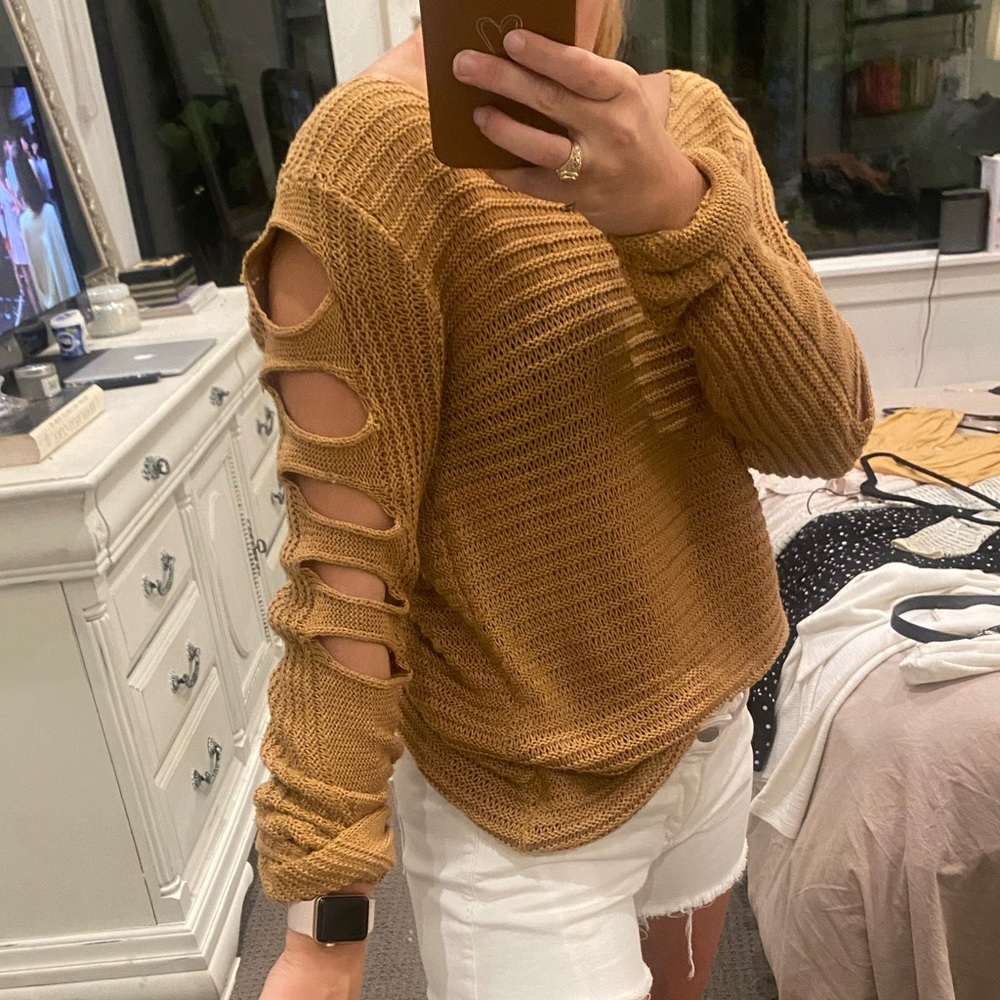 Tan sweater with cutouts in the sleeves